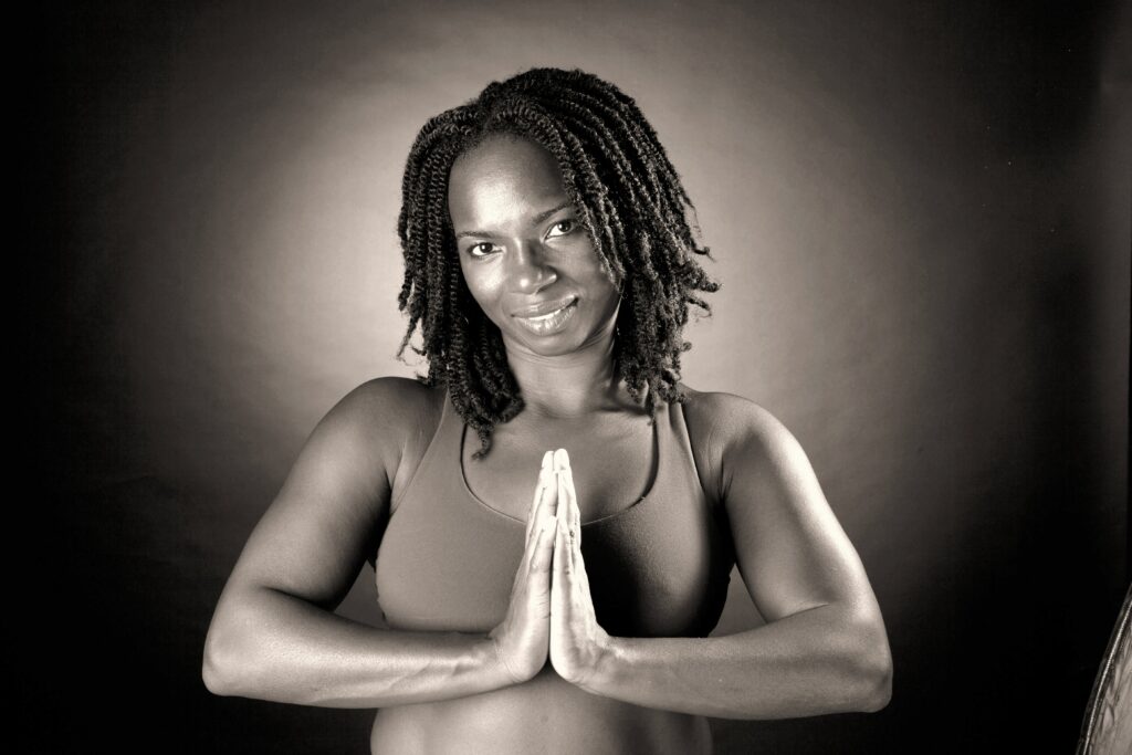 A woman with dreadlocks is doing yoga