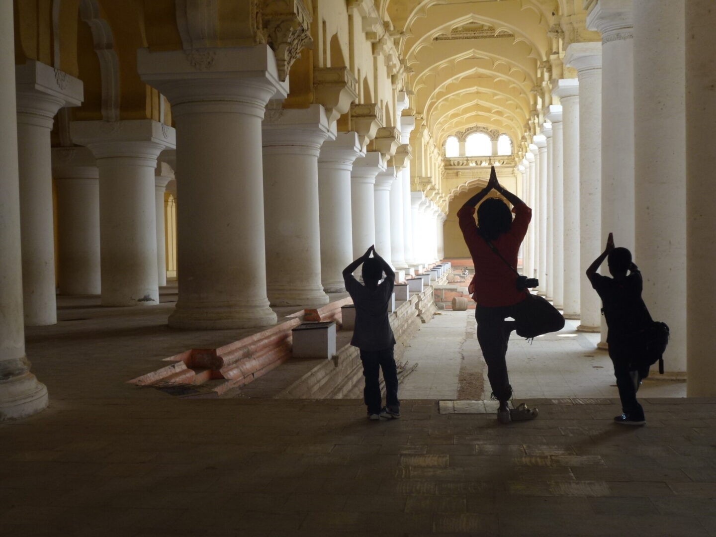 A group of people doing yoga in an old building.