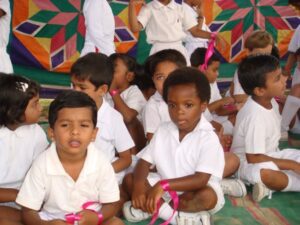 Children sitting together in a colorful setting.