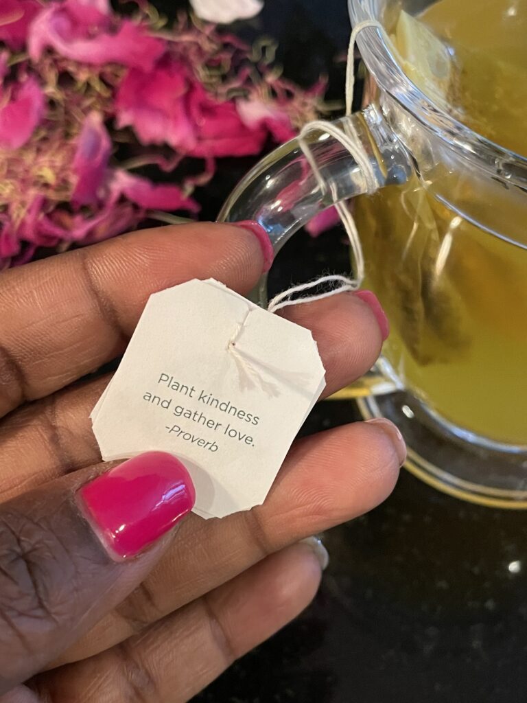 A person holding up a tea bag with the words " please, pardon me.