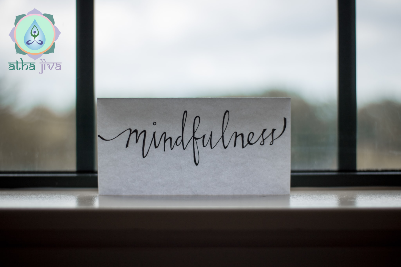 A card that says mindfulness on the window sill.
