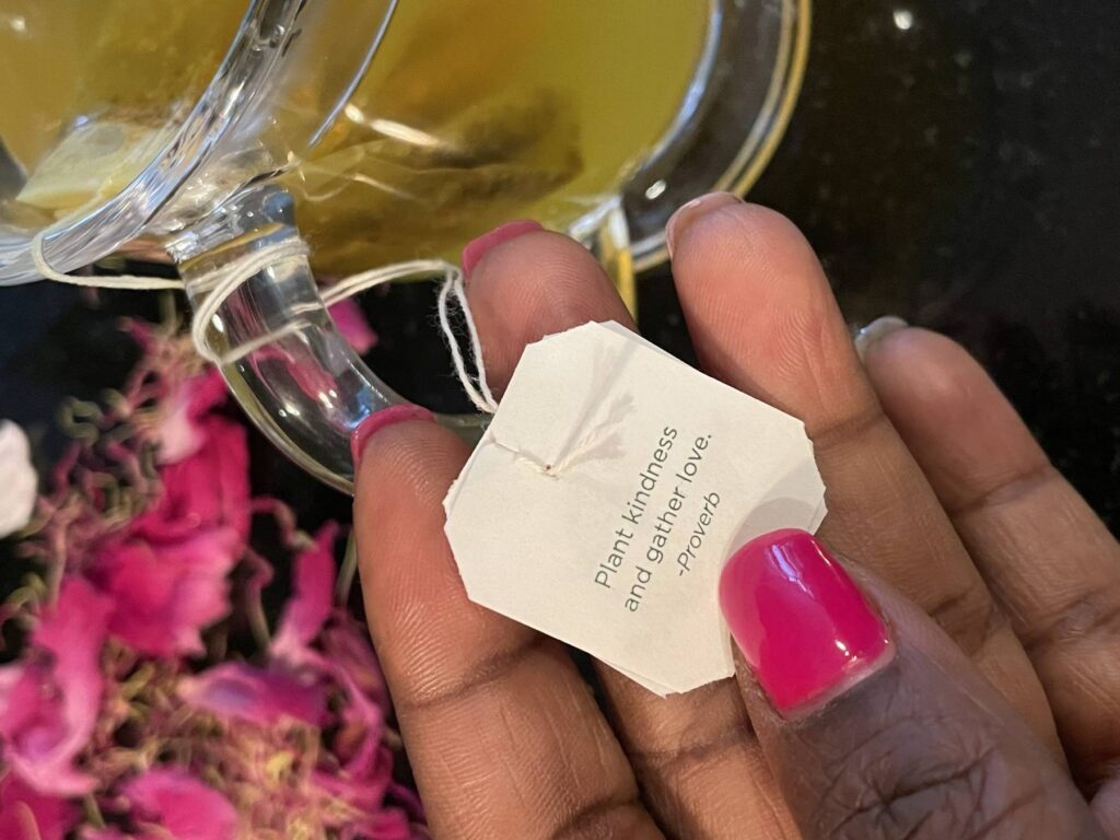 A person holding up a tea bag with the words " please, pardon me.